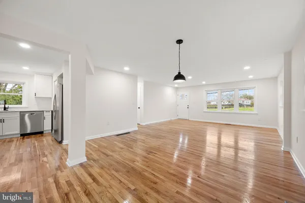 a view of a kitchen with a sink and a refrigerator