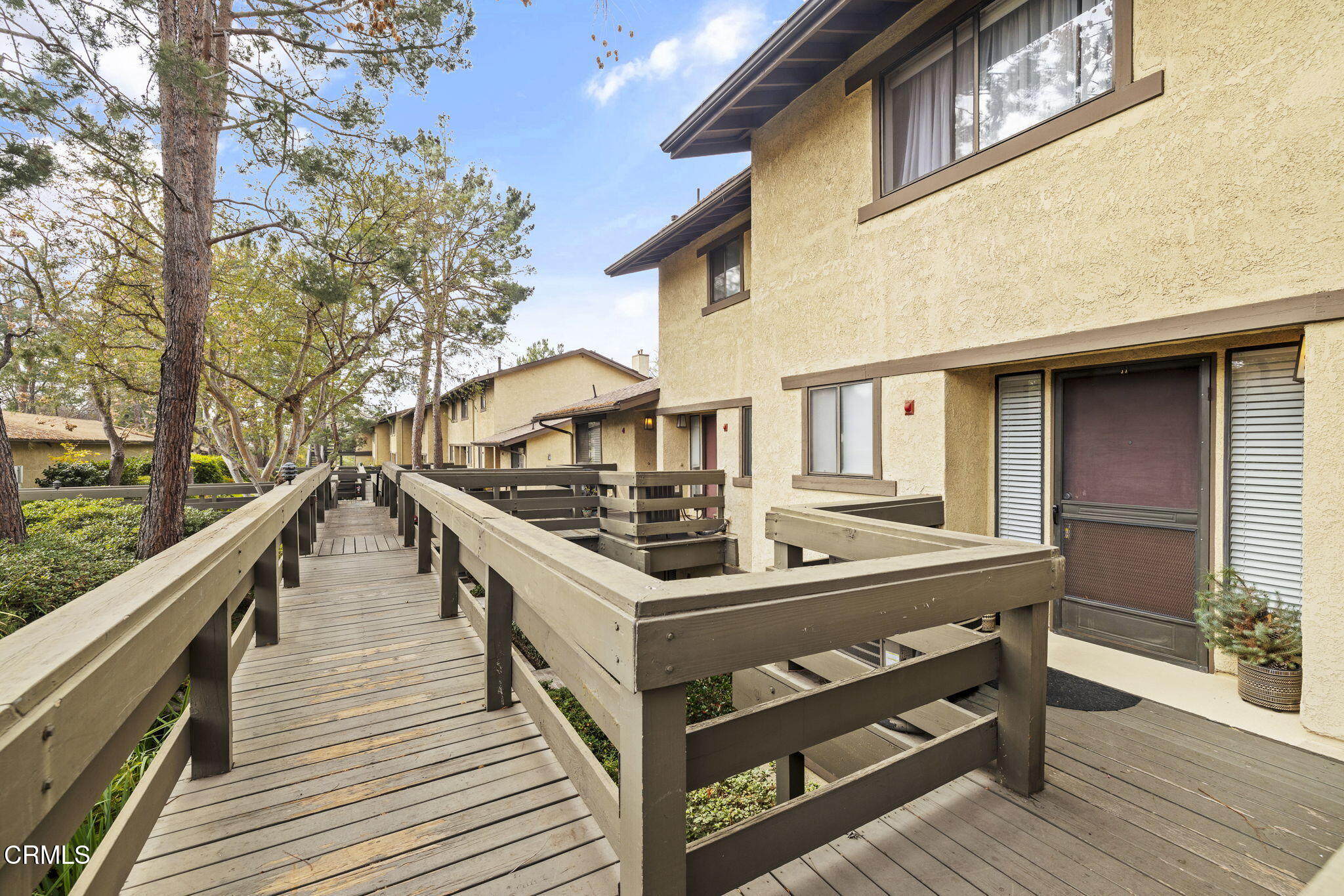 a view of a house with pool and wooden deck
