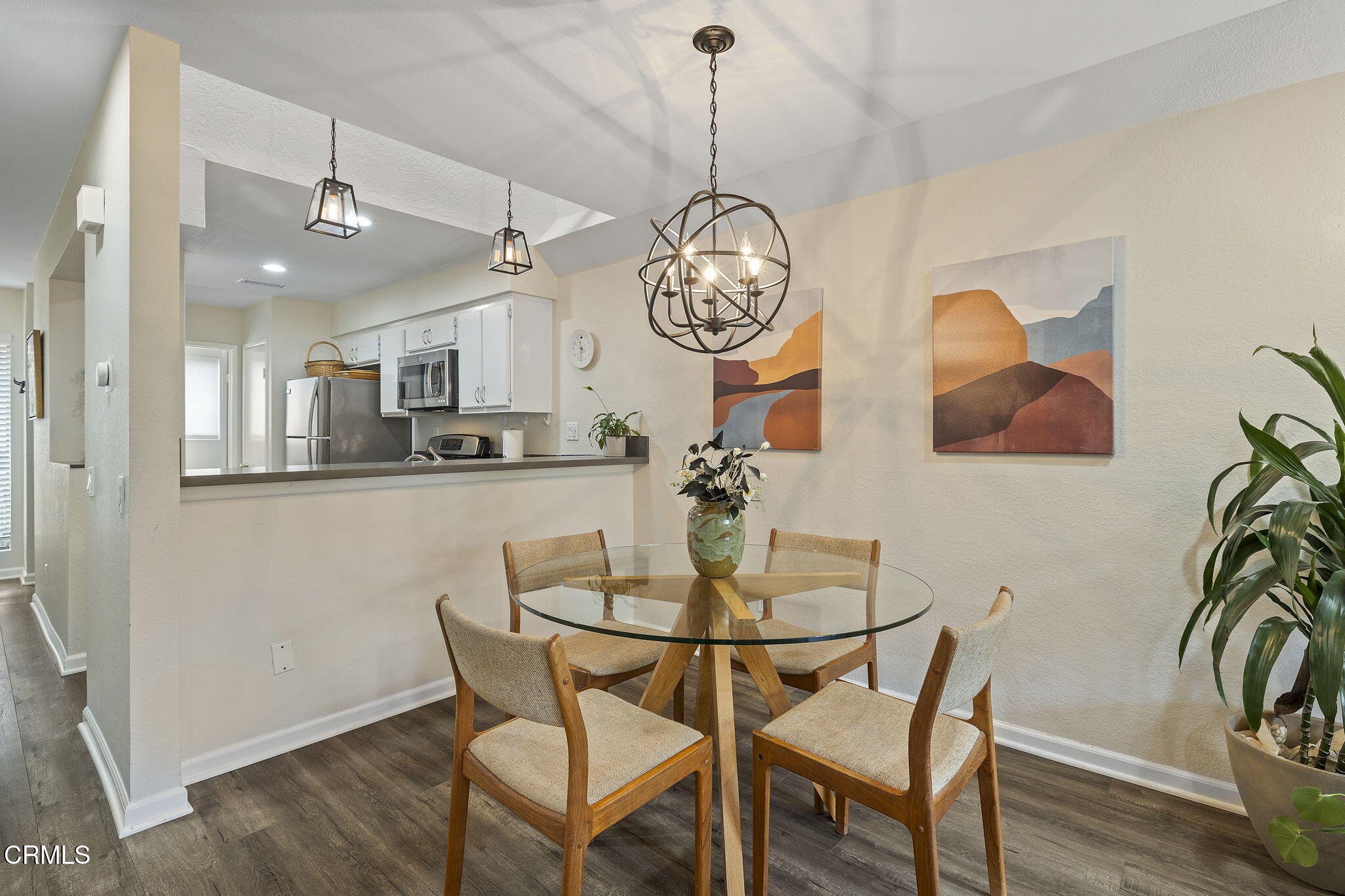 1052 Seco Street, Unit 206 Pasadena, CA 91103 - Photo 11 of 35 a view of a dining room with furniture a chandelier and wooden floor