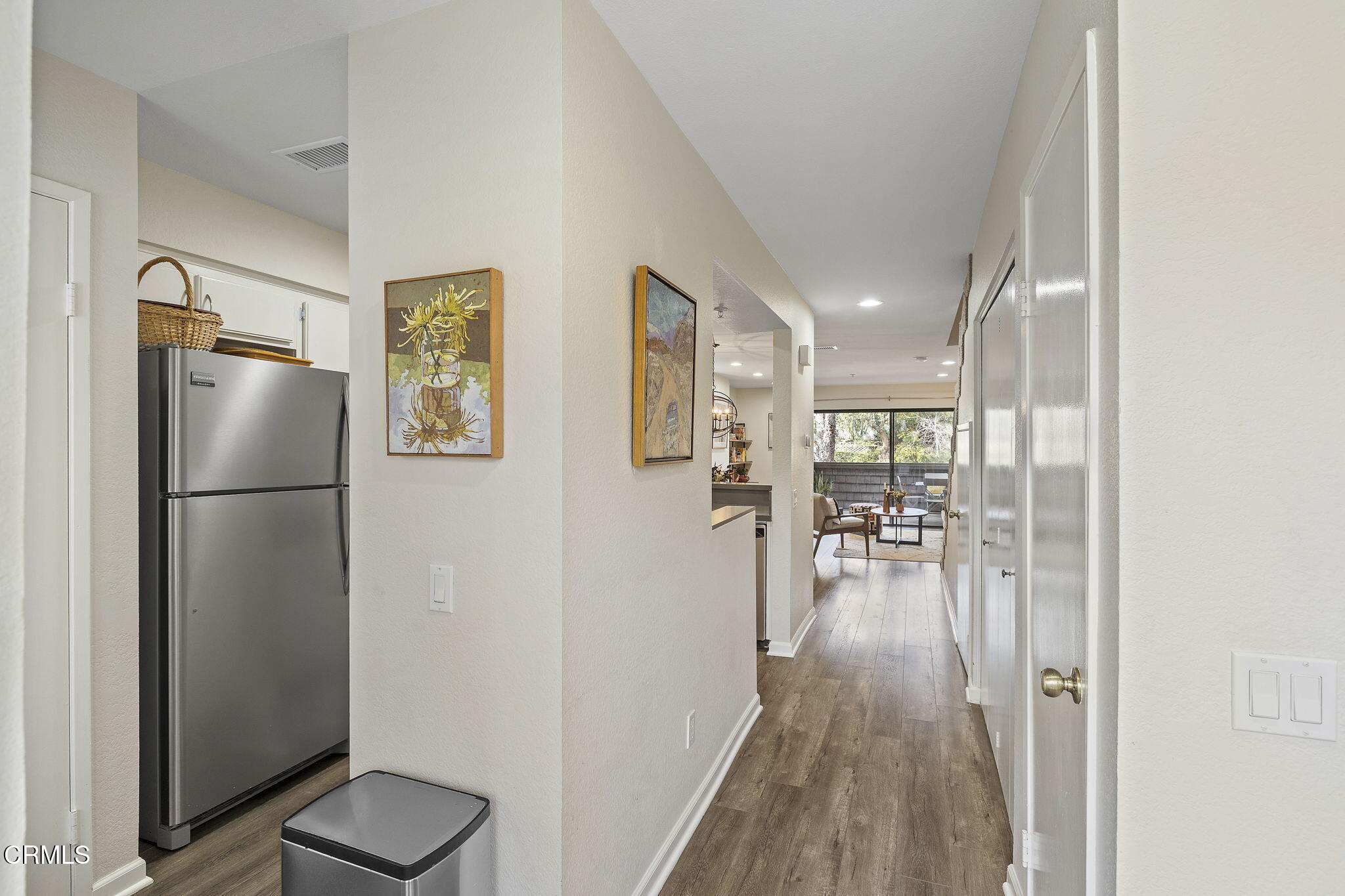 1052 Seco Street, Unit 206 Pasadena, CA 91103 - Photo 3 of 35 a view of a hallway to a livingroom with wooden floor and furniture