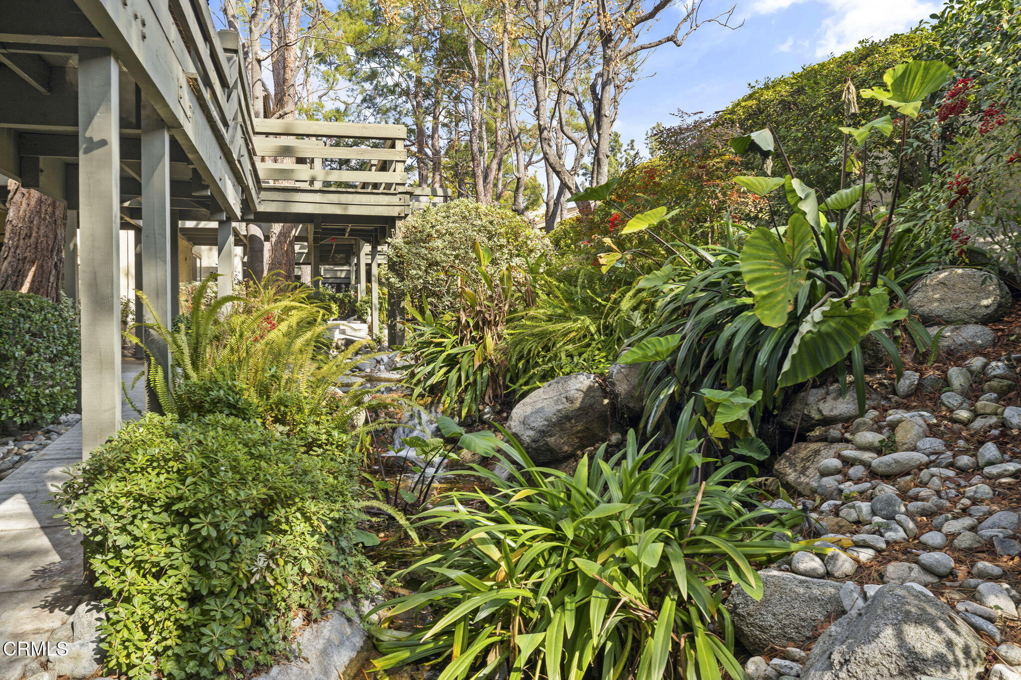 1052 Seco Street, Unit 206 Pasadena, CA 91103 - Photo 31 of 35 a sign that is in front of flowers