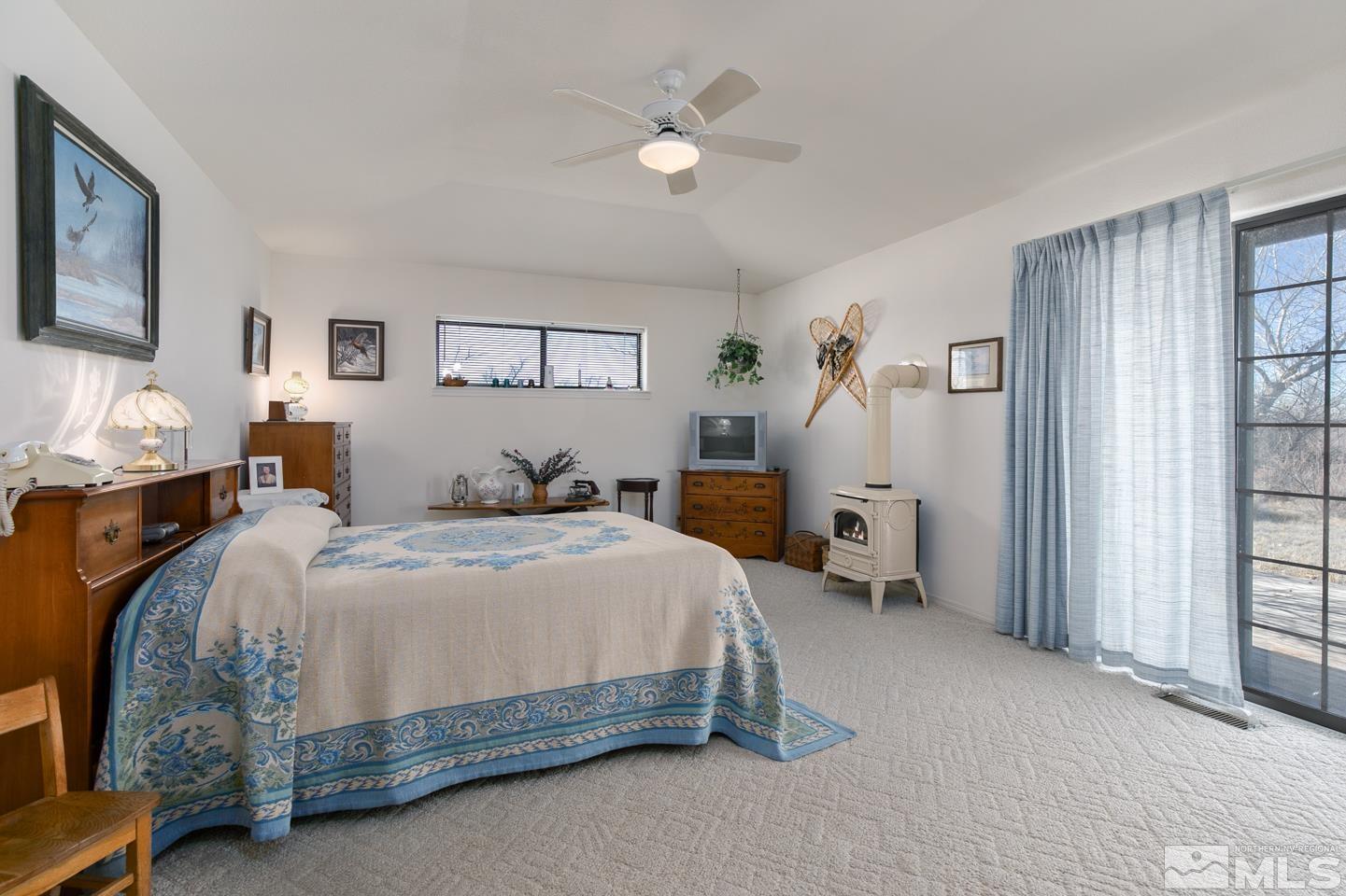 3812 Boyer Road Fallon, NV 89406 - Photo 11 of 40 a bedroom with a bed and a chandelier