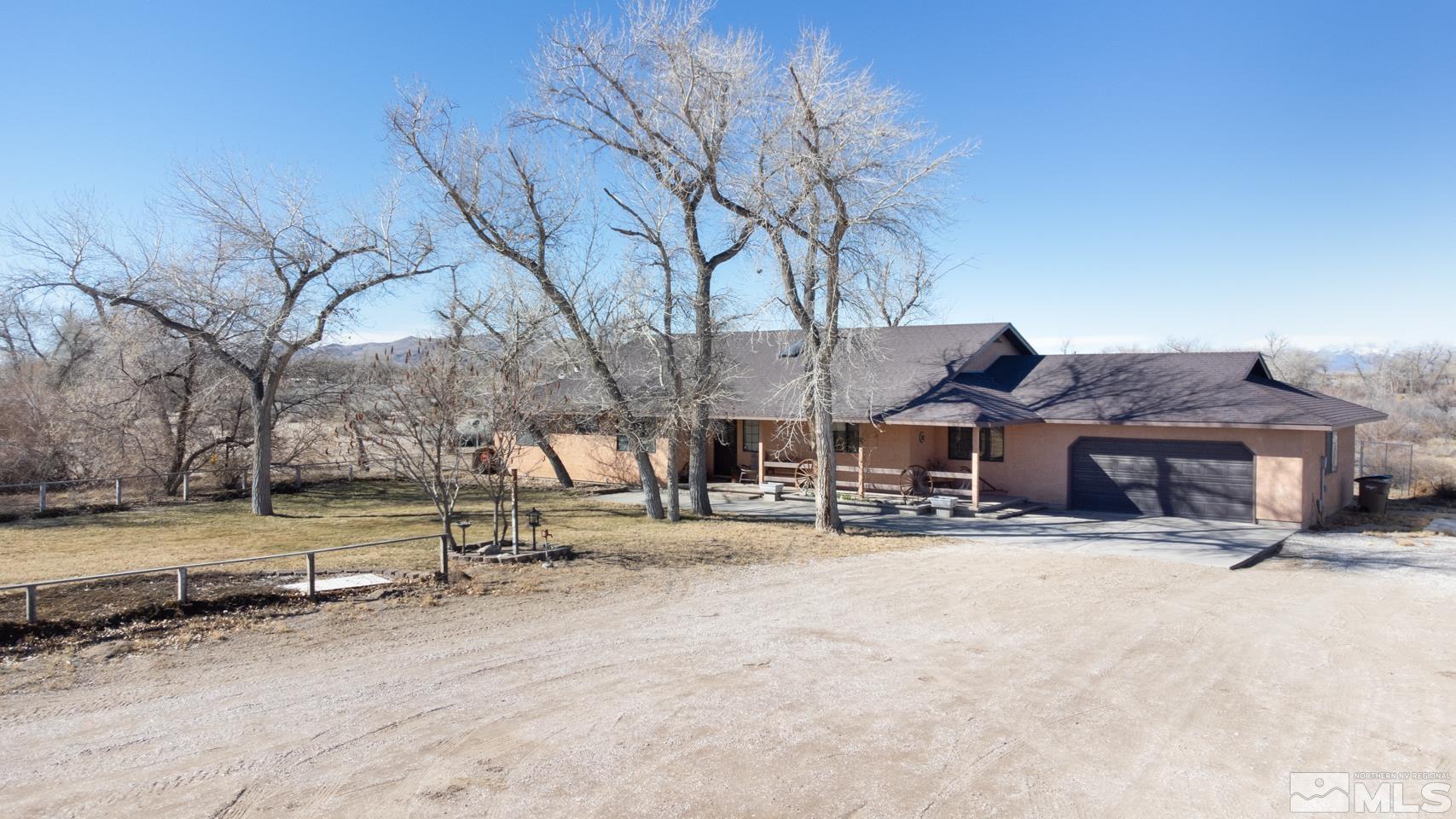 3812 Boyer Road Fallon, NV 89406 - Photo 34 of 40 a backyard of a house with fire pit and trees
