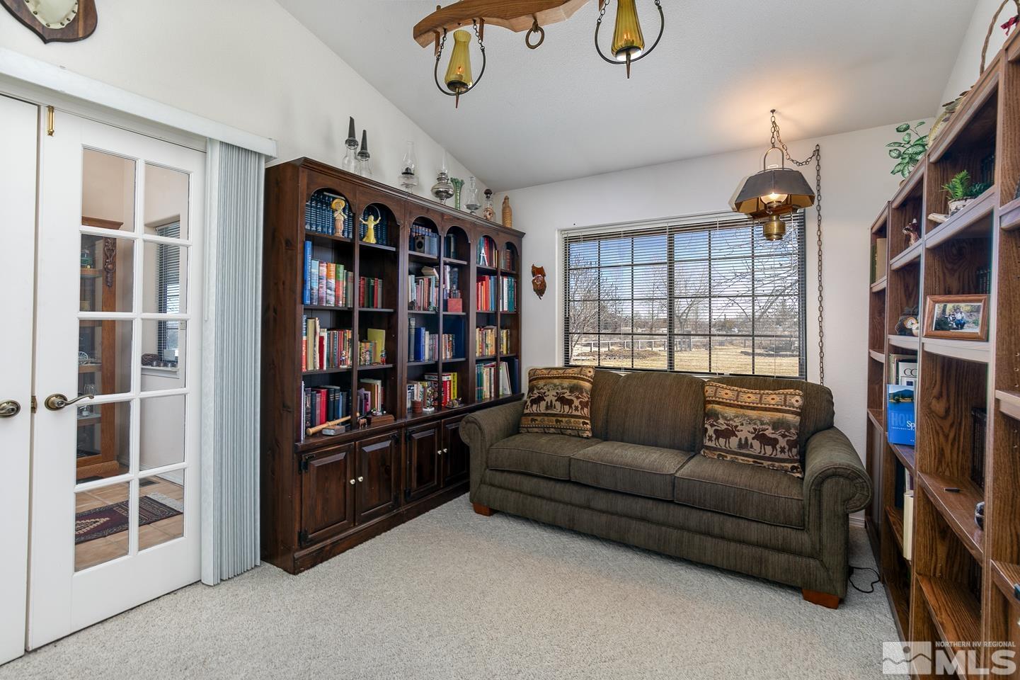 3812 Boyer Road Fallon, NV 89406 - Photo 7 of 40 a living room with furniture a flat screen tv and a bookshelf