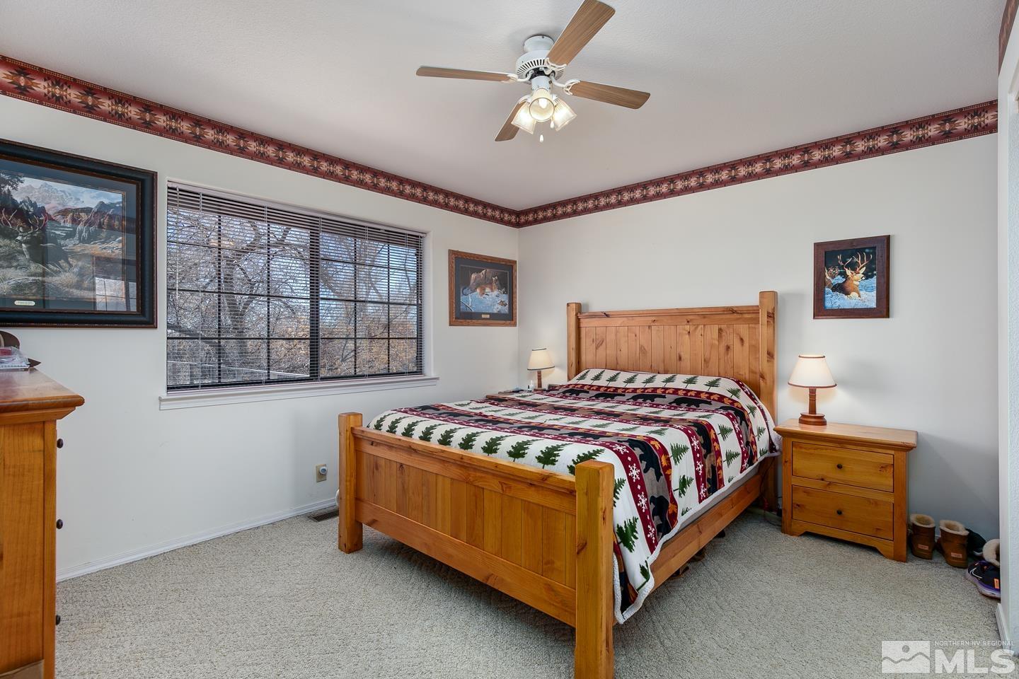 3812 Boyer Road Fallon, NV 89406 - Photo 8 of 40 a bedroom with a bed and a chandelier