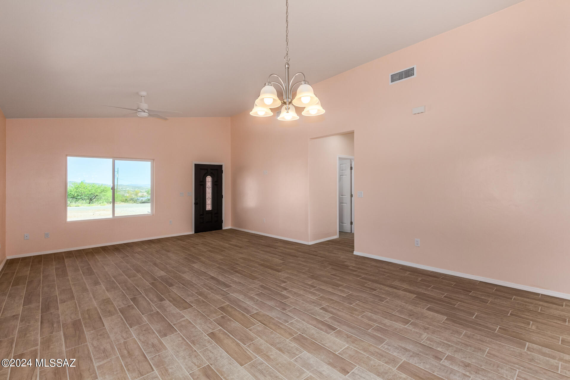 91 Avenida De Las Naciones Rio Rico, AZ 85648 - Photo 8 of 36 a view of a livingroom with a chandelier fan and wooden floor