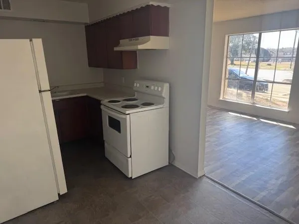 a view of a kitchen with a stove top oven