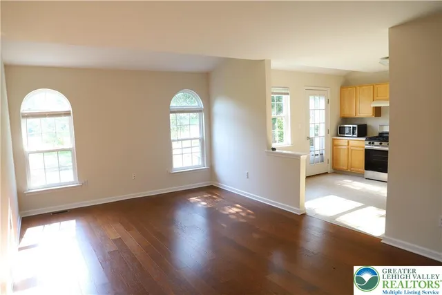 a kitchen with a refrigerator a stove a sink a washer dryer and cabinets