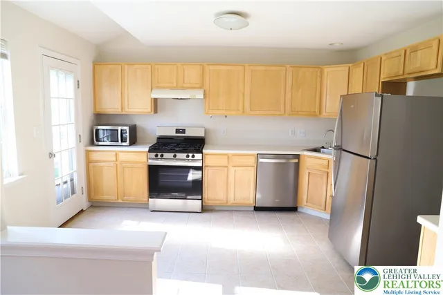 a view of a kitchen with wooden floor
