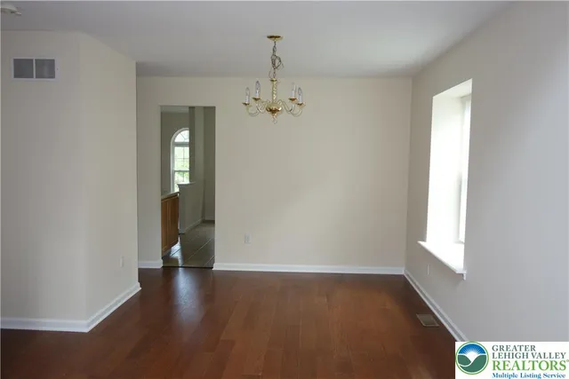 a view of a livingroom with a ceiling fan and window