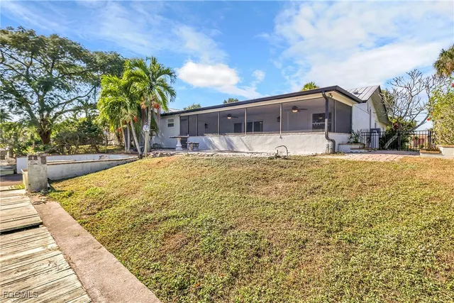 a large house with a large tree in front of it