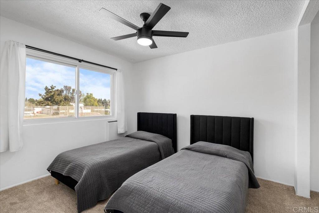 1640 Maple Drive, Unit 53 Chula Vista, CA 91911 - Photo 17 of 52 a bedroom with two beds and a large window