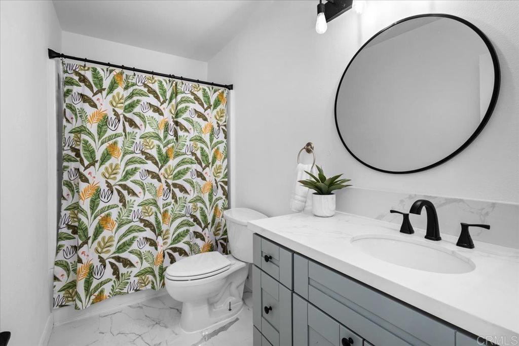 1640 Maple Drive, Unit 53 Chula Vista, CA 91911 - Photo 20 of 52 a bathroom with a sink a toilet and a mirror
