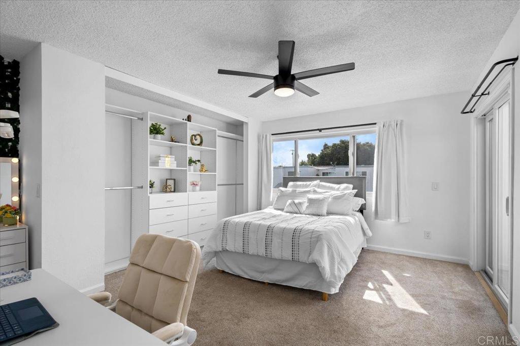 1640 Maple Drive, Unit 53 Chula Vista, CA 91911 - Photo 24 of 52 a bedroom with a large bed couch and a window