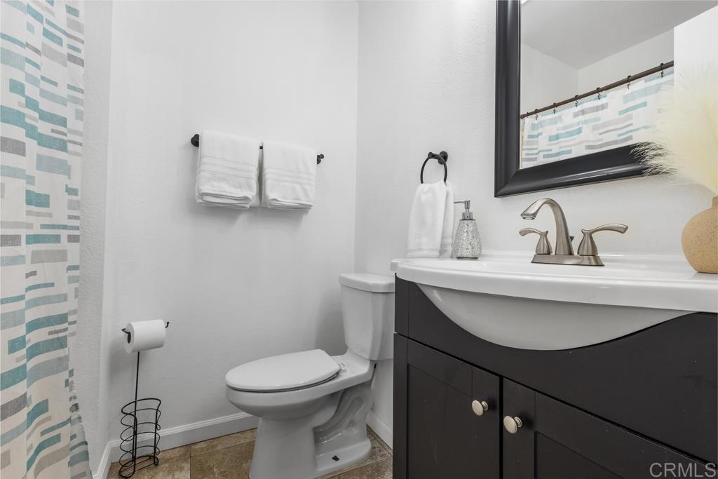 1640 Maple Drive, Unit 53 Chula Vista, CA 91911 - Photo 26 of 52 a bathroom with a toilet sink and mirror