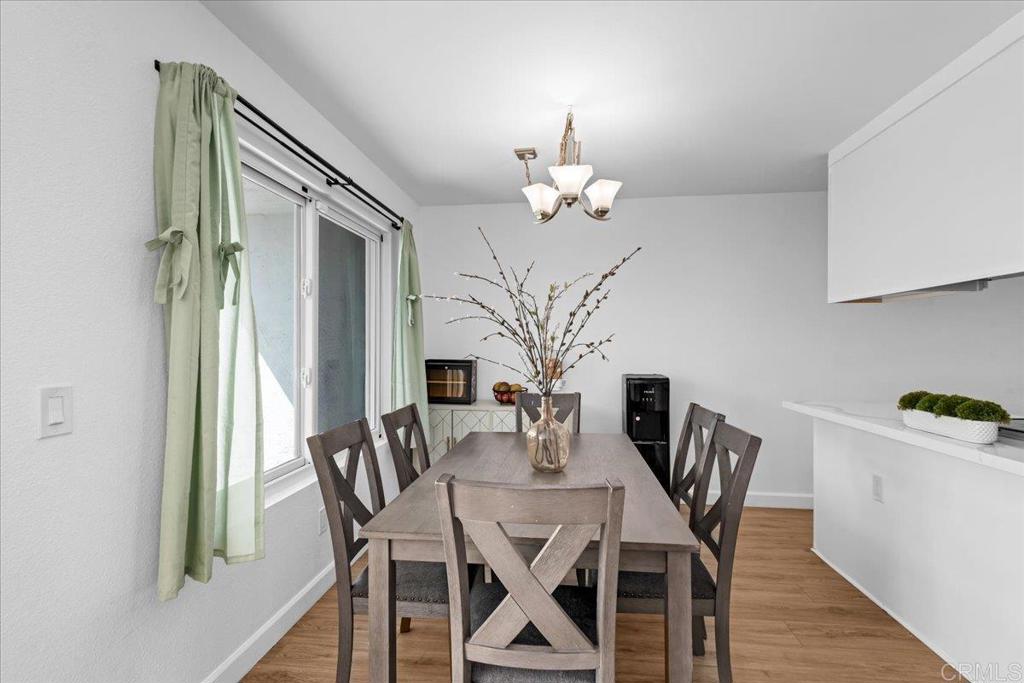 1640 Maple Drive, Unit 53 Chula Vista, CA 91911 - Photo 3 of 52 a view of a dining room with furniture wooden floor and chandelier