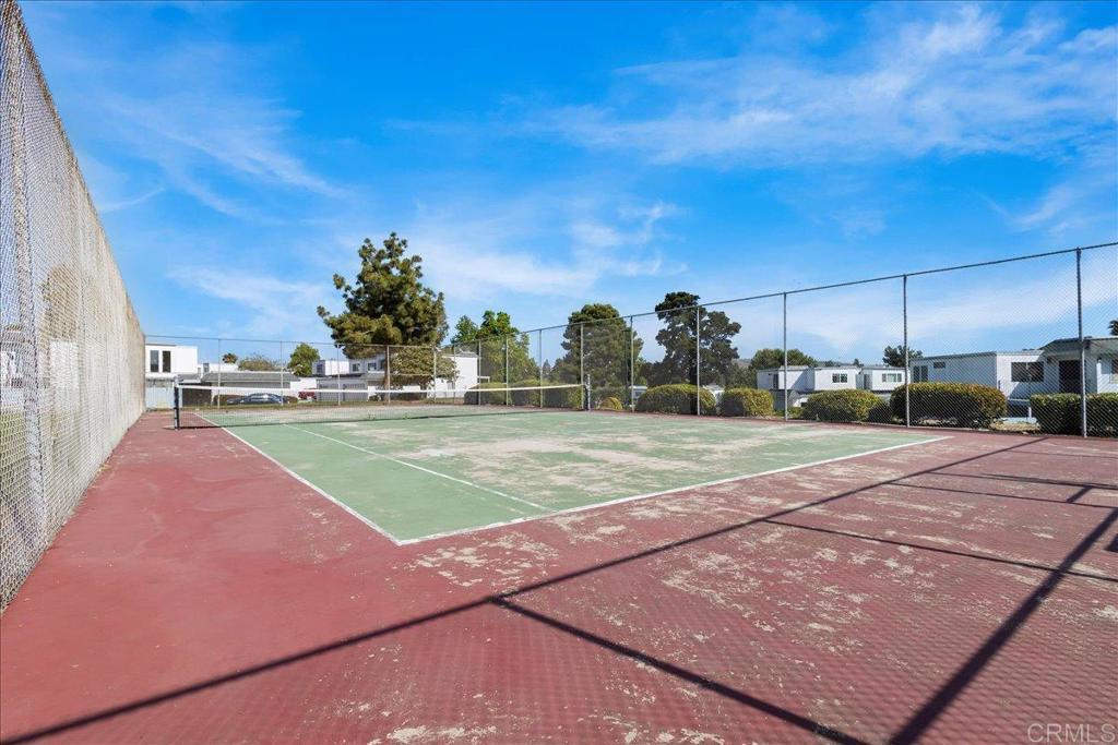 1640 Maple Drive, Unit 53 Chula Vista, CA 91911 - Photo 45 of 52 a view of a tennis ground with large trees