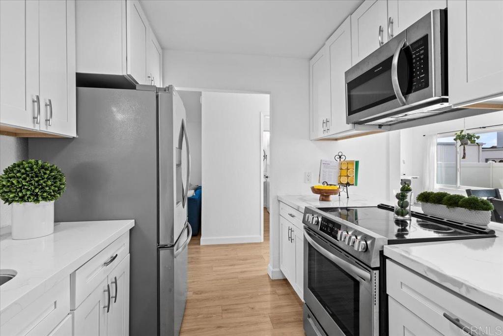 1640 Maple Drive, Unit 53 Chula Vista, CA 91911 - Photo 5 of 52 a kitchen with stainless steel appliances a stove microwave and refrigerator