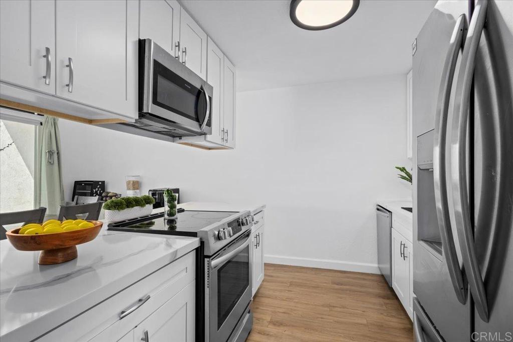 1640 Maple Drive, Unit 53 Chula Vista, CA 91911 - Photo 6 of 52 a kitchen with stainless steel appliances granite countertop a sink a stove and a refrigerator