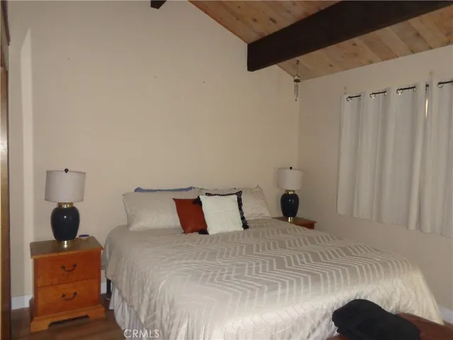 a bedroom with a bed and a mirror