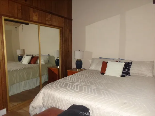 a bedroom with a bed and a mirror