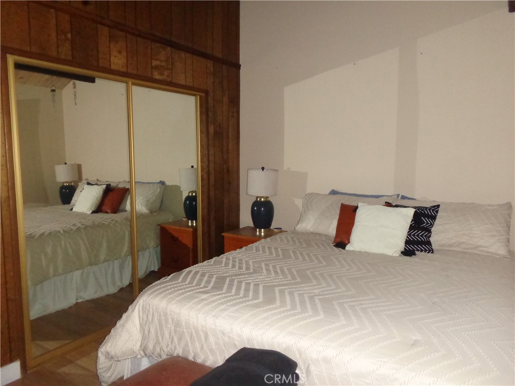 24273-24273 Horst Drive Crestline, CA 92325 - Photo 14 of 34 a bedroom with a bed and a mirror
