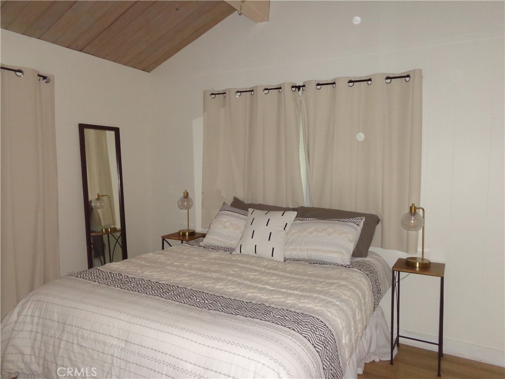 24273-24273 Horst Drive Crestline, CA 92325 - Photo 15 of 34 a bedroom with a bed and a mirror