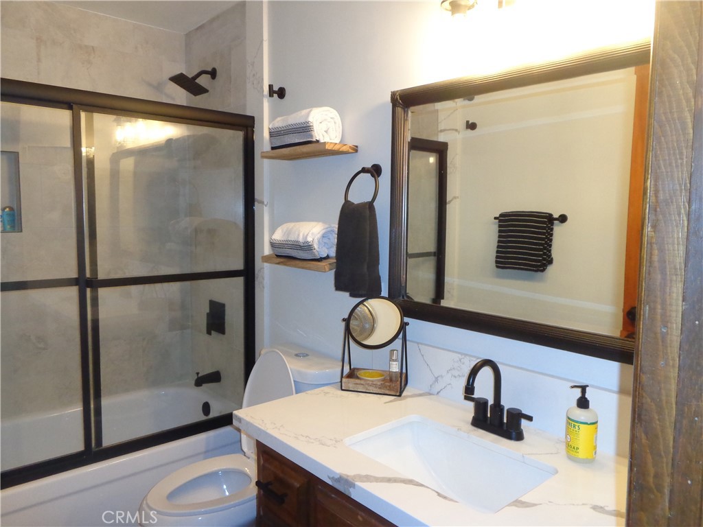 24273-24273 Horst Drive Crestline, CA 92325 - Photo 22 of 34 a bathroom with a sink a toilet and shower