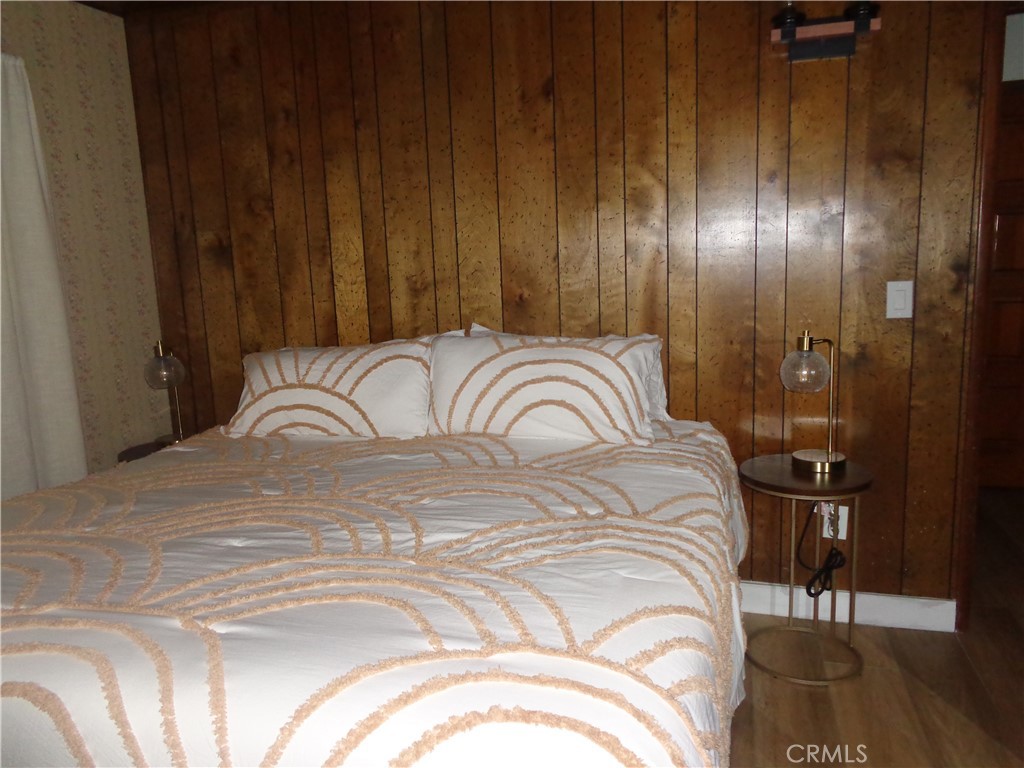 24273-24273 Horst Drive Crestline, CA 92325 - Photo 5 of 34 a bedroom with a bed and a mirror