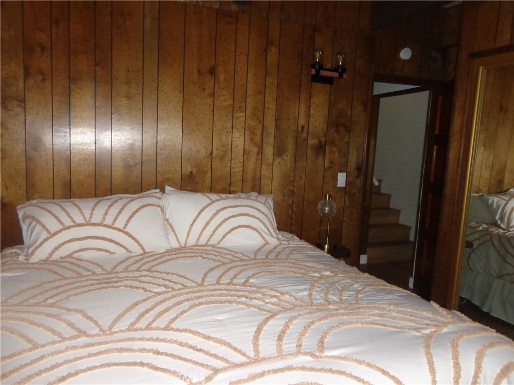 24273-24273 Horst Drive Crestline, CA 92325 - Photo 6 of 34 a bedroom with a bed and a mirror