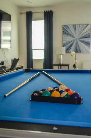 a room with pool table and a window