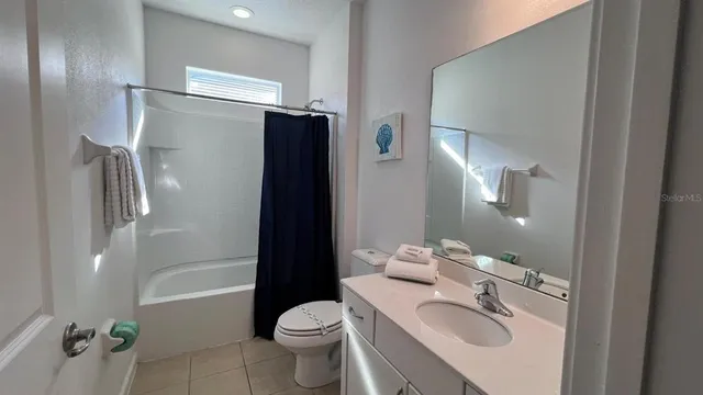 a bedroom with bed and wooden floor