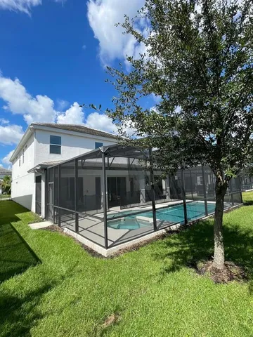 a view of a house with a backyard