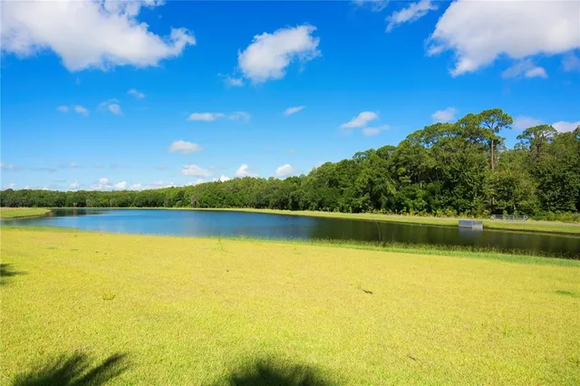 a view of a swimming pool with outdoor seating