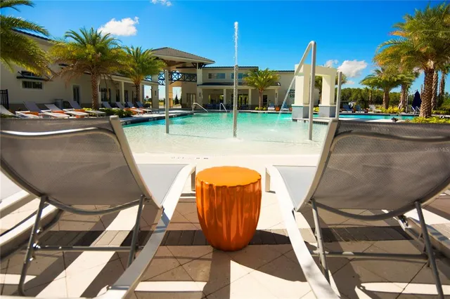 a view of swimming pool with seating space