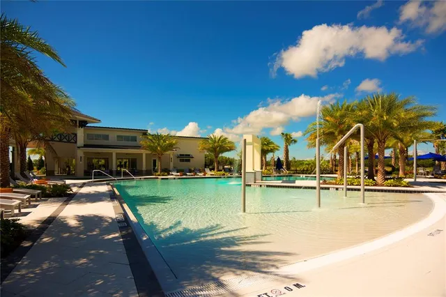a view of a swimming pool with lounge chairs