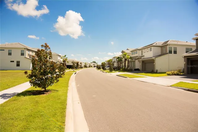 a view of swimming pool with outdoor seating and house in the background