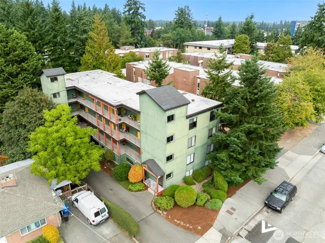 an aerial view of a house with a yard basket ball court and outdoor seating