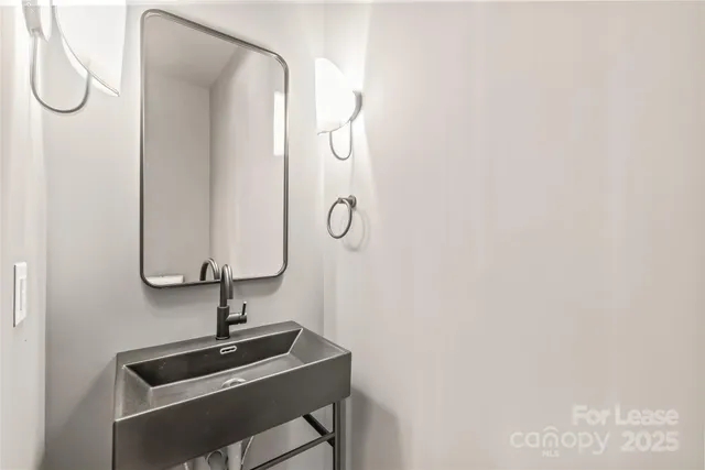 a bathroom with a sink and mirror