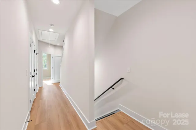 a view of a hallway with wooden floor