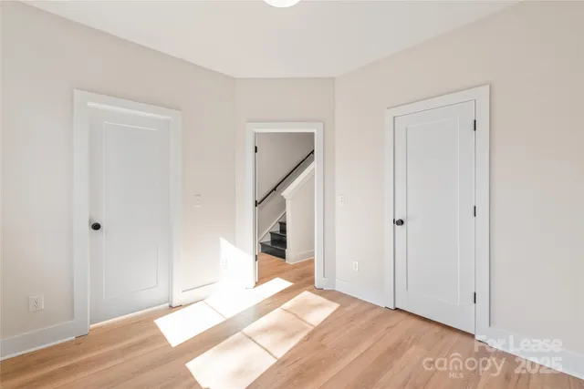a view of an empty room and wooden floor
