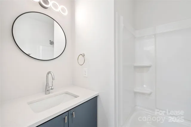 a bathroom with a sink and mirror