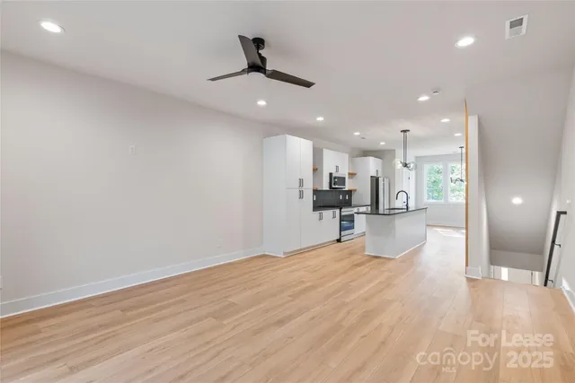 a view of a kitchen with a refrigerator and a window