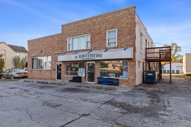 a view of a house with a patio and a yard