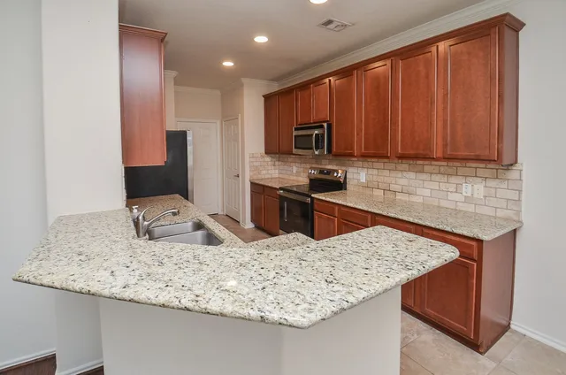 a bathroom with a sink double vanity mirror and a bathtub