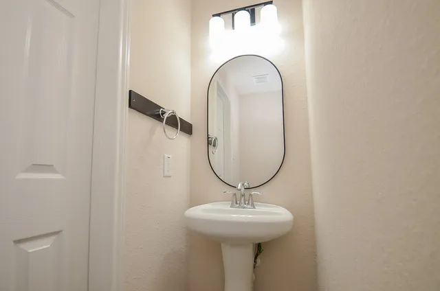 an empty room with a window and a ceiling fan