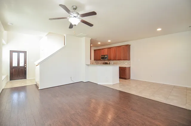 a view of kitchen with granite countertop cabinets and window