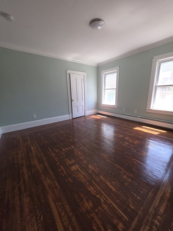 44-th 19th Street, Unit 2 Lowell, MA 01850 - Photo 5 of 5 an empty room with wooden floor and windows