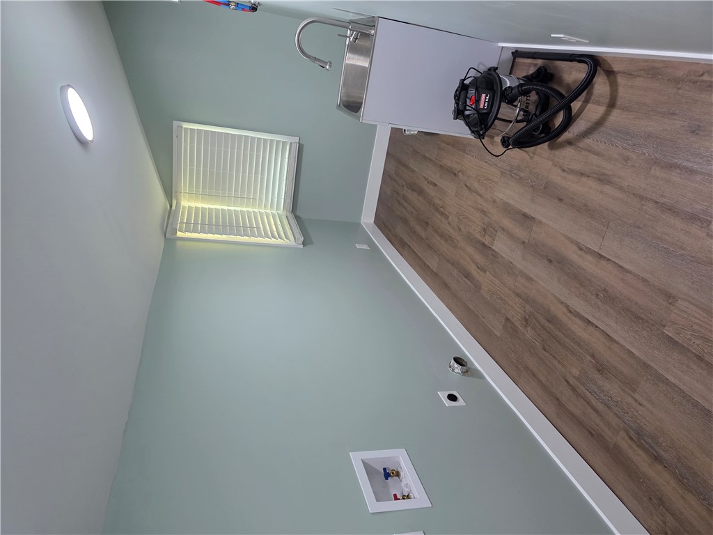 112 Simmons Street Anderson, SC 29625 - Photo 9 of 26 Functional laundry room offers a utility sink, light flooring, and ample space.