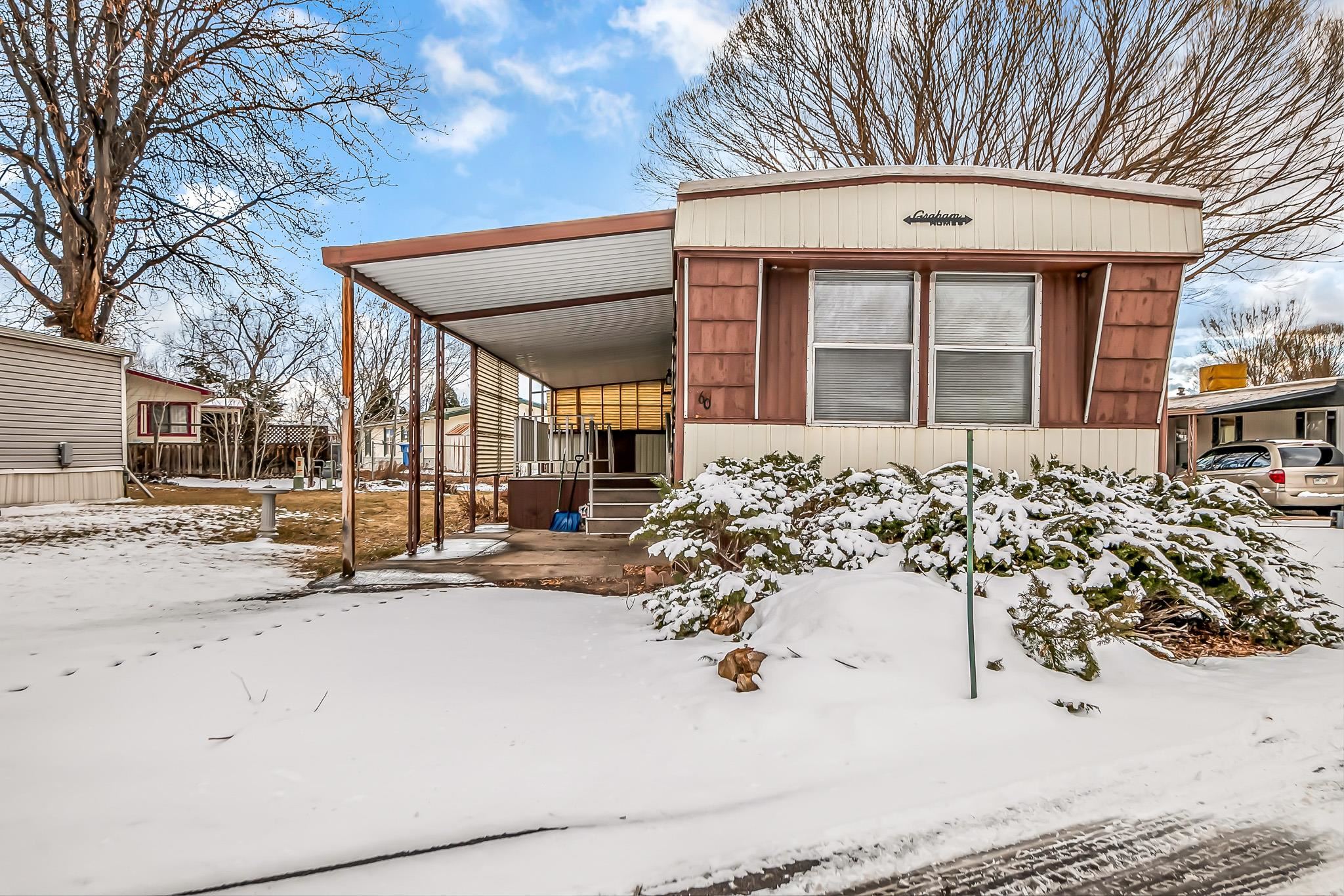 a view of a house with snow on the road